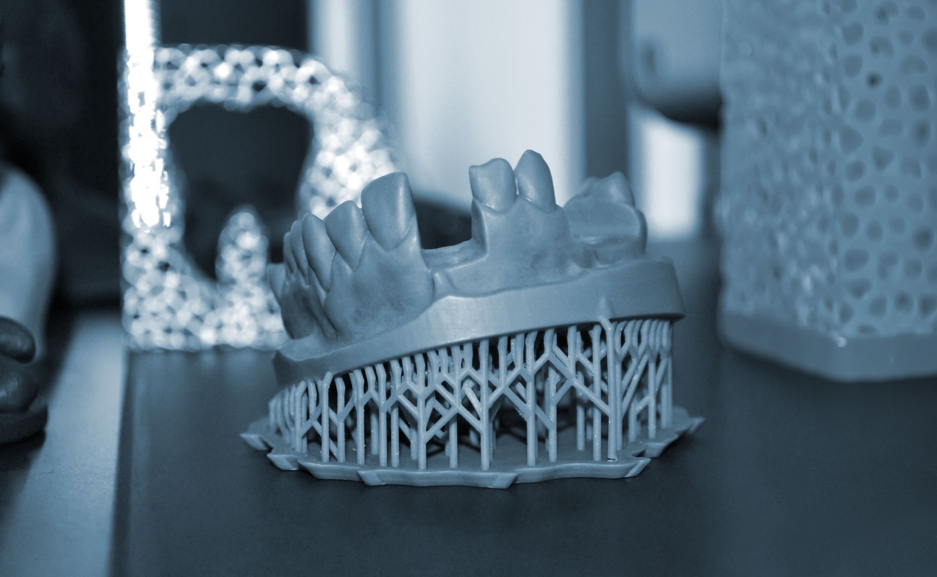 White prototype of the human foot skeleton printed on 3d printer on dark surface